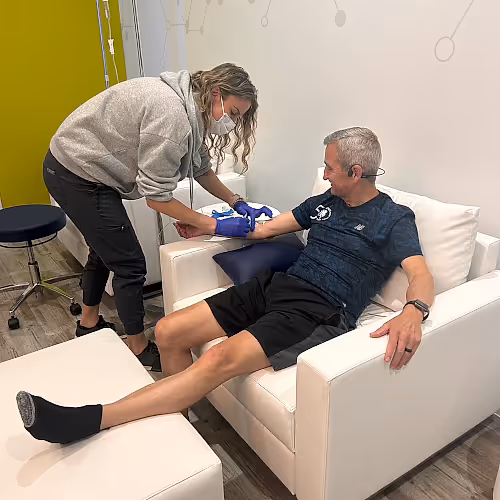 Licensed nurse monitoring a client’s IV infusion to ensure comfort and safety